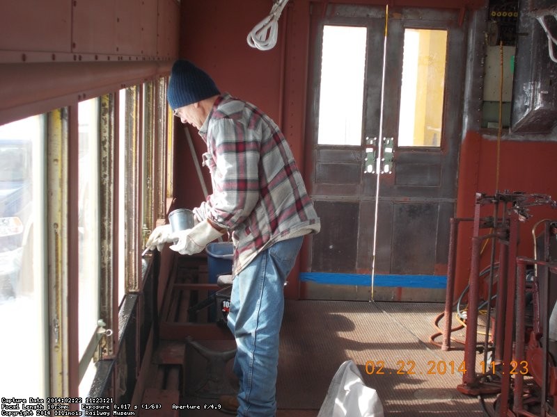 Early in the am Gary is painting the metal window sill.  Its cold.2-22-14   DSCN0730