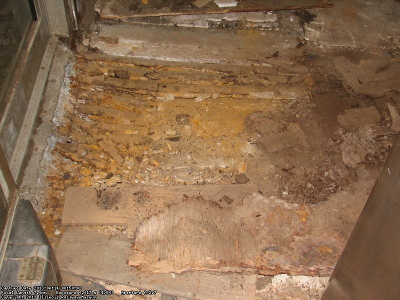 Another view of the damage in front of the door in the galley area of the Birmingham prior to vacuuming debris. 