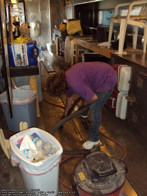 Shelly Vanderschaegen vacuuming the galley floor 7/14/13