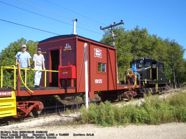09.12.07 - HENRY VINCENT HAS CHANGED THE POLE PRIOR TO CHANGING DIRECTION ON THE MAINLINE.  JOHN AND JAMES FAULHABER ARE ON THE DECK OF THE CABOOSE, ENJOYING THE RIDE.
