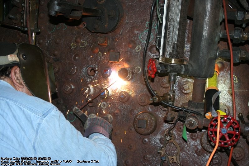 Dennis welds a socket into place