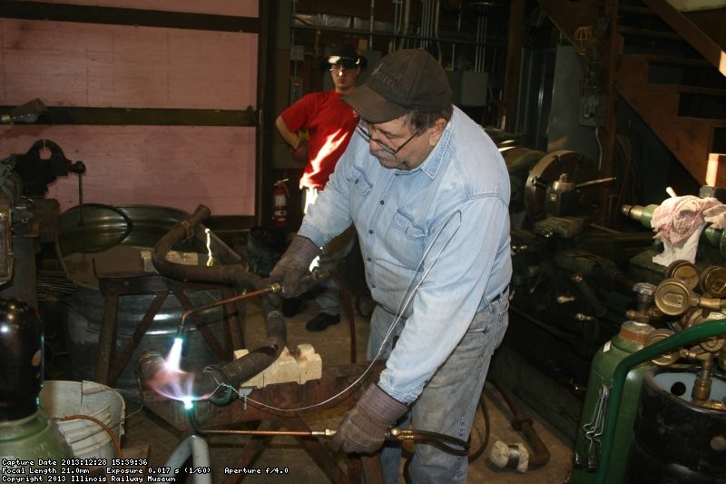 Dennis heats the copper pipe