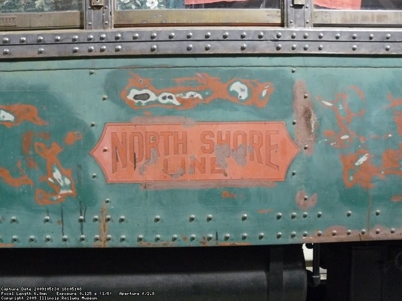 A very faded North Shore herald on CNSM 749. The outline was painted with red spray paint, and then a decal containing the black and gold was placed over it to complete the herald.