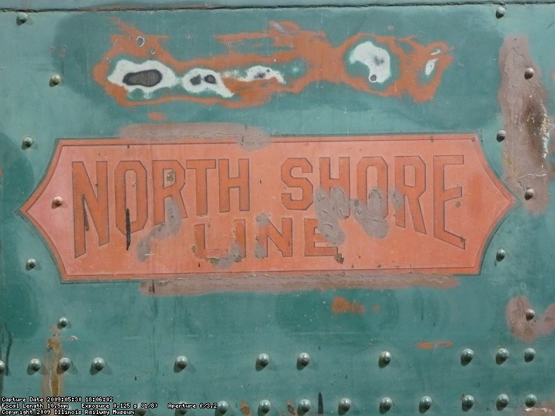 A very faded North Shore herald on CNSM 749. The outline was painted with red spray paint, and then a decal containing the black and gold was placed over it to complete the herald.