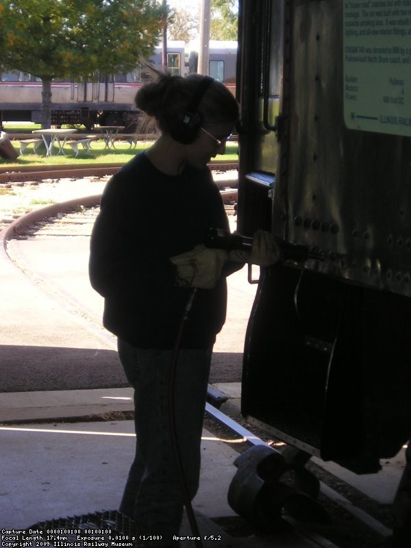 October 17, 2004, Gwyn uses an air hammer to press in bent steel on the sides of 749.