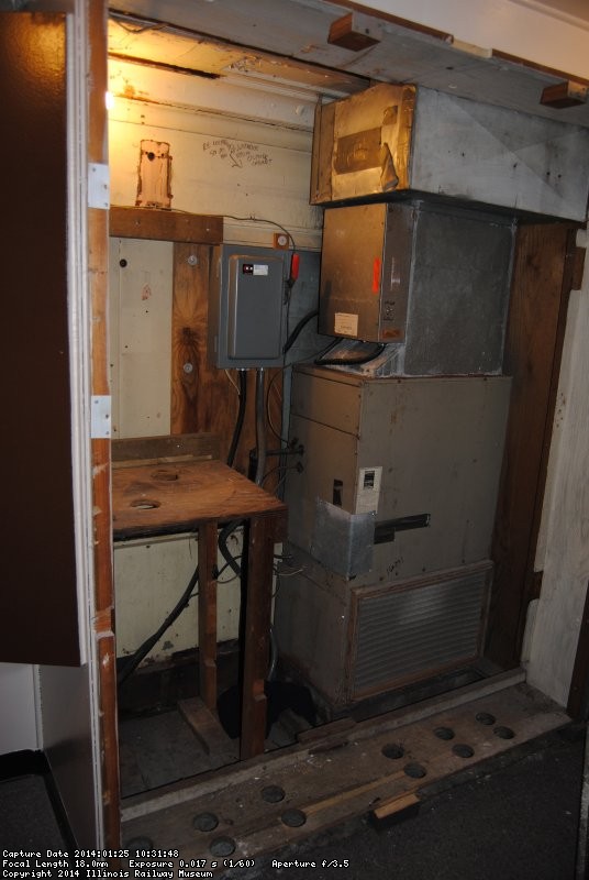 The former cabinet to the left of the furnace
