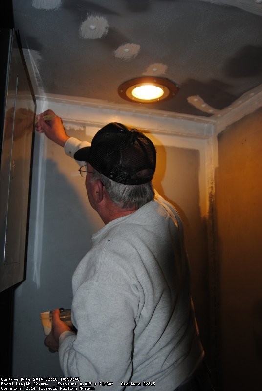 Kevin applying primer to walls in the vestibule