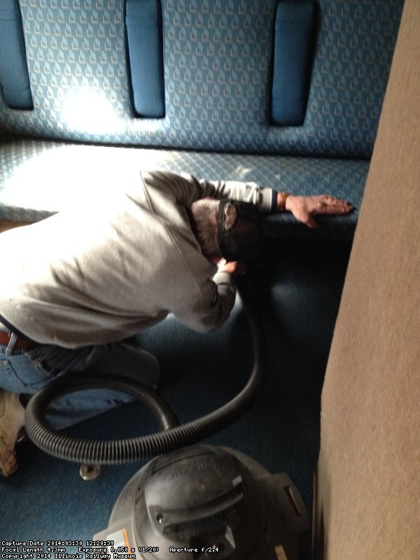 Kevin Kriebs vacuuming in a coach