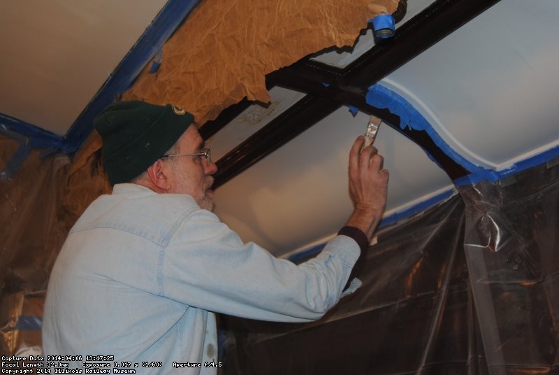 Buzz Morisette painting the lower part of the Ely dining room ceiling