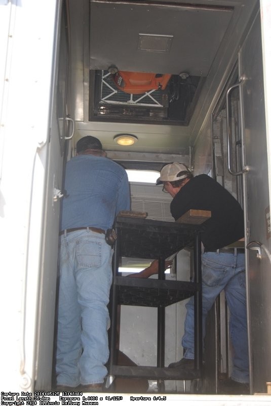 Michael Baksic and Andy Townsend work to position the AC unit  - Photo by Shelly Vanderschaegen