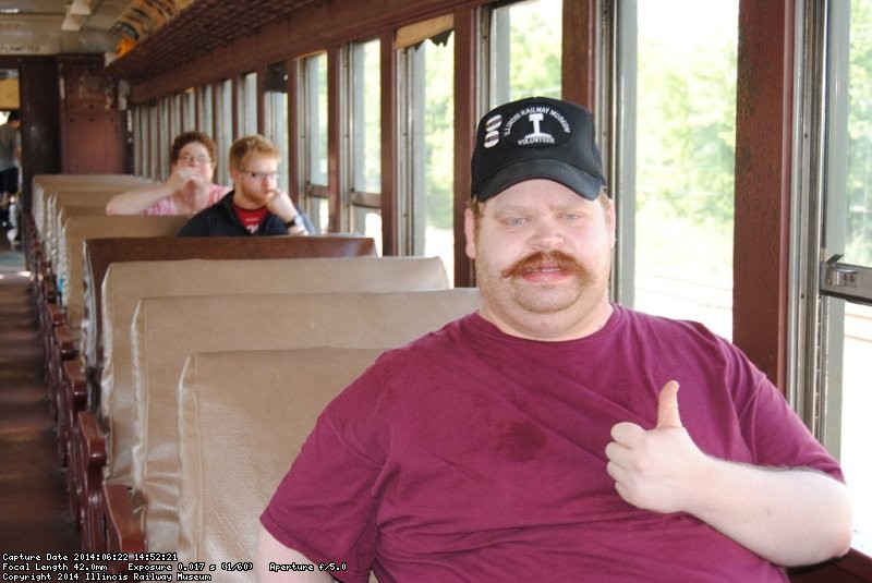 David gives the thumbs up inside the coach train. Behind him are his brother and mother - Photo by Shelly Vanderschaegen 