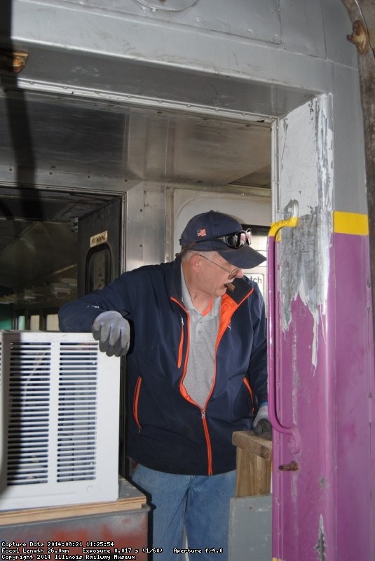 Ray Mormann helping to remove air conditioners - Photo by Shelly Vanderschaegen