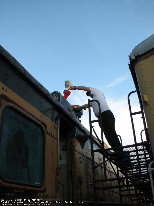 Brian LaKemper pouring antifreeze into the Dyno hot-water heating system - Photo by Pauline Trabert