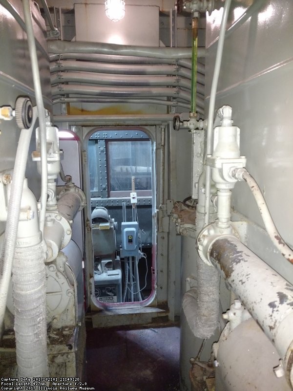 Standing at the middle door on the left side of the loco looking at the right middle door. The expansion tank for the #2 is on the right and the #1 on the left.