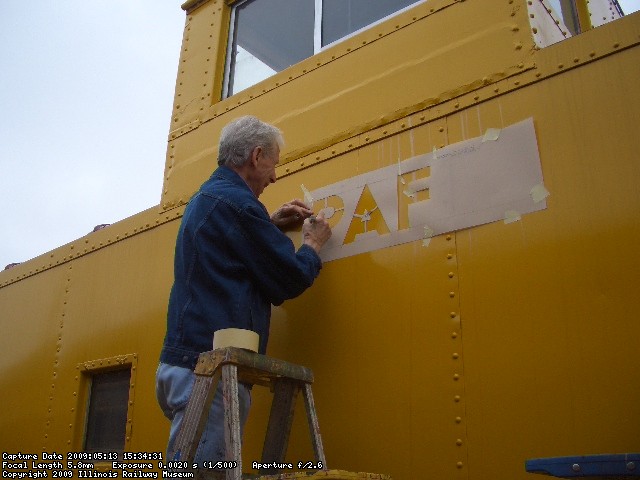 05.13.09 - BILL IS APPLYING THE STENCIL SO THAT HE CAN TRACE THE RAILROAD NAME.