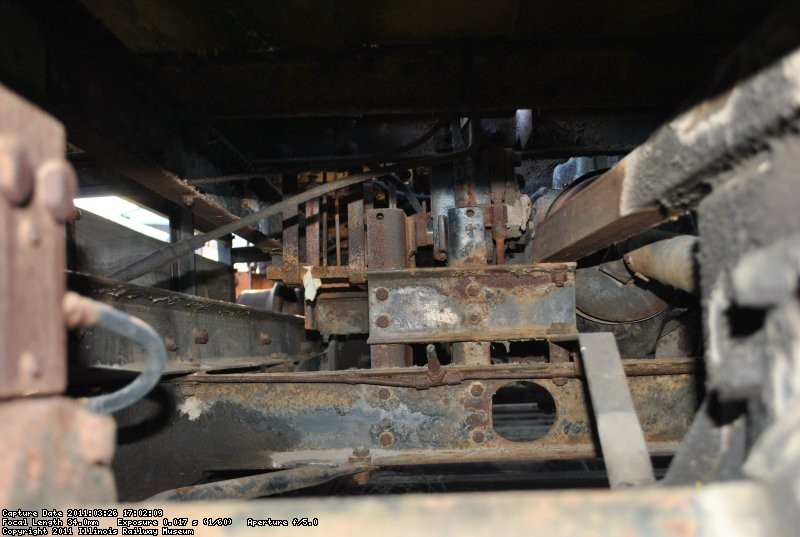 Looking toward the front of the machine. A lot of the support in the center is for a turntable that doesn't exist anymore.  The hole in the frame is where the second drive shaft runs between the two axles