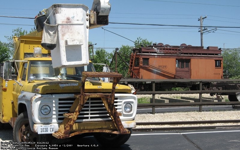 Bucket truck and line car at the depot
