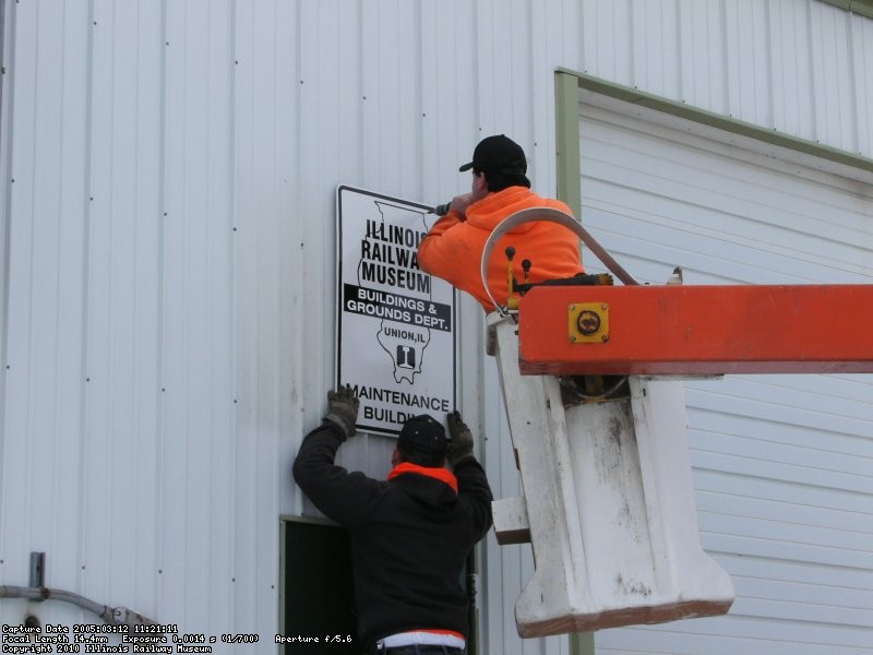 Putting up the new B&G Dept sign (03/12/2005).