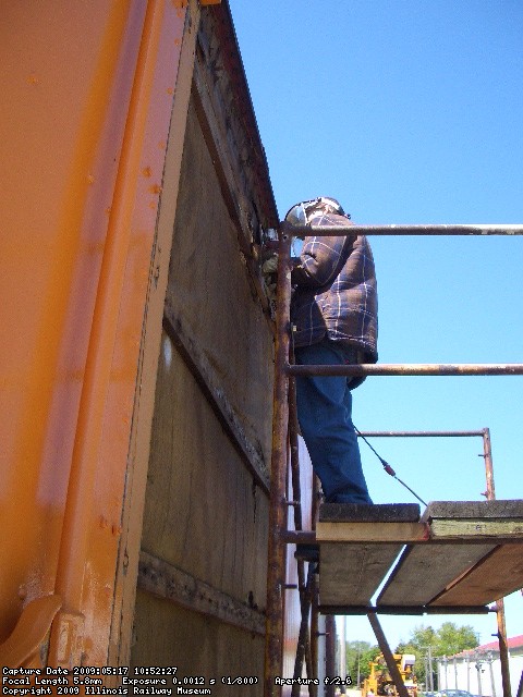 05.17.09 - JOHN BALETTO HAS RETURNED AND IS GRINDING OFF THE STUBS OF THE RUSTED DOOR TRACK BOLTS.