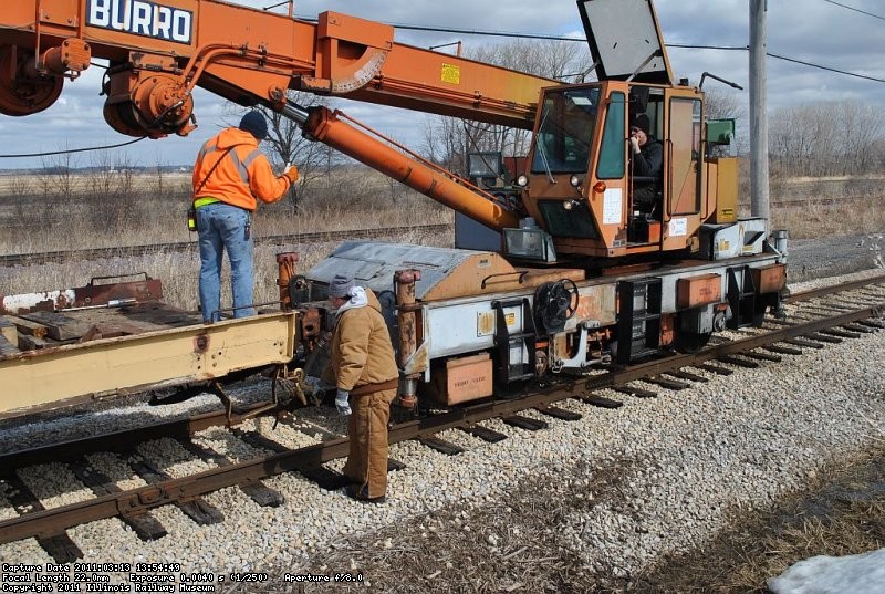 Jeron Glander and Patrick Shea prepare to cut off the crane to pull a bundle of ties off the flatcar.  Tom Hunter is running the crane. 3-13-11