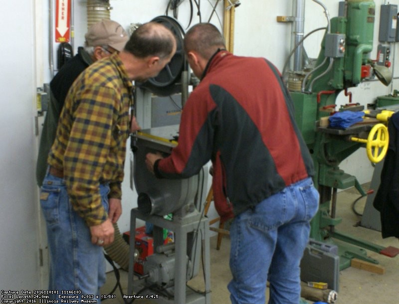 The band saw team replacing and tuning up the saw. Photo by Buzz Morisette.