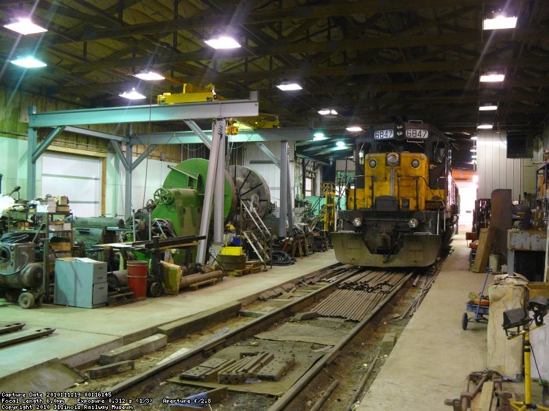 CNW 6847 in the steam shop next to the large wheel lathe and over head crane.