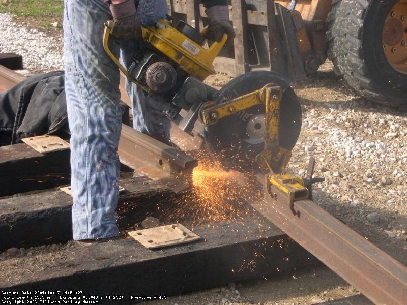 Tom H. cutting rail in Yard 10 for the barn  Oct 2004