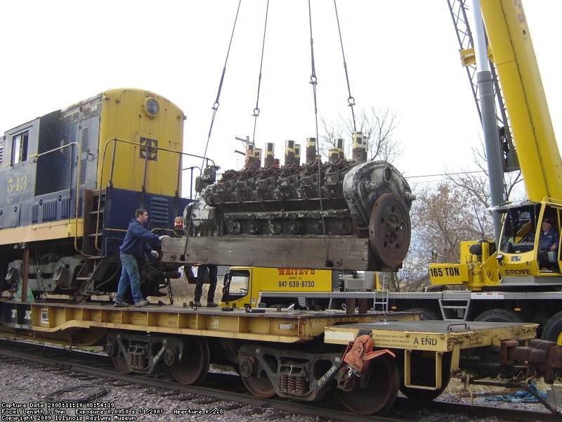 The rare 12 cylinder Winton engine is lifted off the flat car 1st in preparation to unloading the 543. It would be later loaded on IRM's DODX flat car to be taken back to the property.