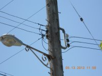 service drop to Schroder store. connections at pole.  Note white insulator on neutral.  Brown insulators on phase wires.