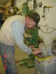 12.18.05 - BOB KUTELLA IS SANDING ONE OF THE RETAINING ARC SEGMENTS SO THAT IT FITS INSIDE OF THE STEEL RIM.