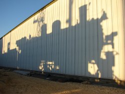 The locomotive casts a shadow on barn 9 as prep for the drop is completed in the late summer light