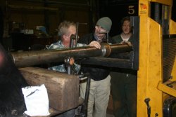 The boring bar is carefully loaded into the mounts on the cylinder