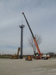 Working together, the crane and forklift get the job done.