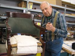 John McKelvey reupholstering a chair for the Lake City