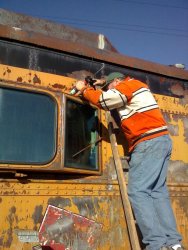 Chuck Trabert applying sealant around Dynamometer bay window on 11/03/13