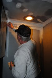 Kevin applying primer to walls in the vestibule