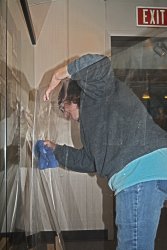 Shelly Vanderschaegen cleaning Plexiglas with Goof Off