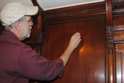 Buzz Morisette demonstrates how to apply wax to Ely mahogany - Photo by Shelly Vanderschaegen