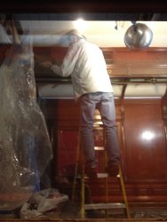 Buzz Morisette removing plastic and painter's tape in the Ely dining room - Photo by Michael McCraren