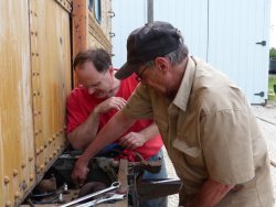 Warren Newhauser and Gary Sherman tensioning the fan belt on the X-5000 Waukesha Enginator - Photo by Brian LaKemper