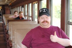 David gives the thumbs up inside the coach train. Behind him are his brother and mother - Photo by Shelly Vanderschaegen 