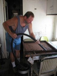 Chuck Trabert vacs loose rust from Dynamometer door frame - Photo by Pauline Trabert