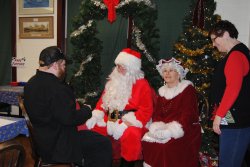 David visits with Santa and Mrs. Claus as Susan Stepek looks on - Photo by Shelly Vanderschaegen