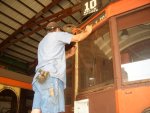 08.12.09 - JOHN FAULHABER IS SANDING THE LETTERBOARD AREA OF THE EAST END OF THE 972 IN PREPARATION FOR PAINTING.