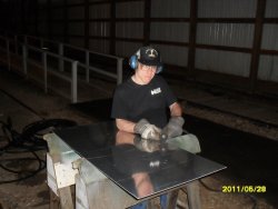 Andy Townsend cutting  Aluminum sheet for future repair of round window in womens washroom. IC 3345 May 2011