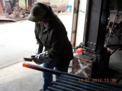 Yes, that's one of our lady volunteers cleaning the tube after it has been heated.  12-1-2012