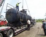 THE TANK IS ON THE TRAILER AND IS BEING SECURED FOR TRANSPORT.