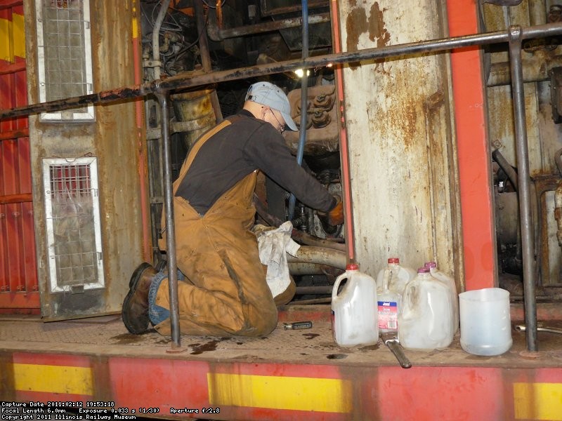 Frank changes the oil in the air compressor.