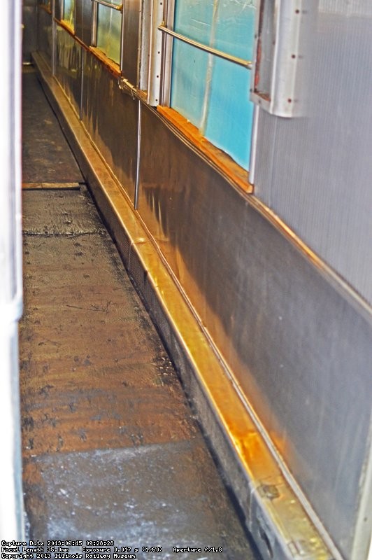 Ray Mormann sprayed the floor with a rubberized spray to help preserve the wood under the plywood to be installed next.