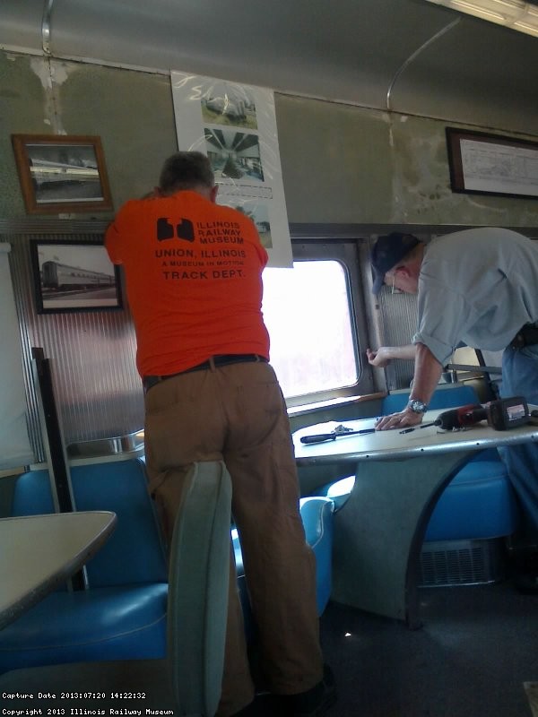 Mark Gellman and Ray Mormann secure a window in the dining area on 7/20/13